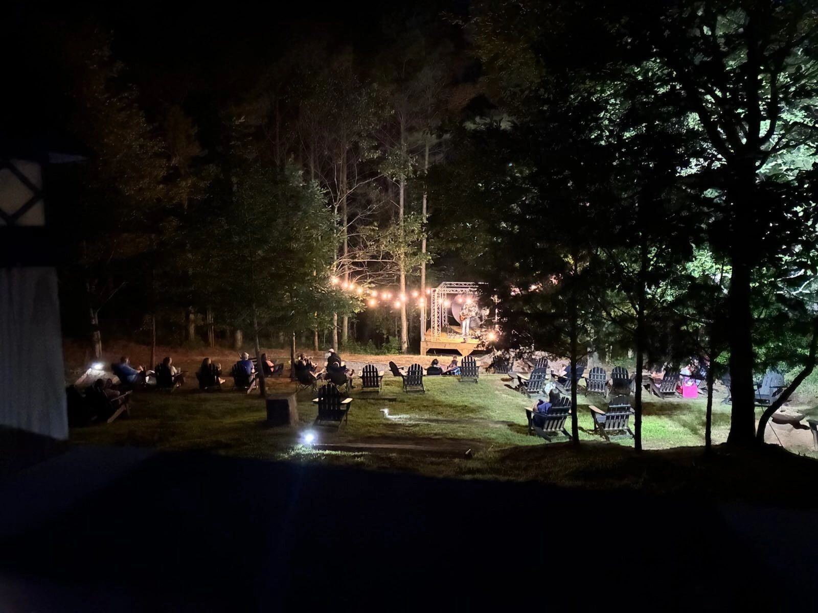 Guests gathered for an outdoor evening concert under string lights at Sasquatch Farm RV Park